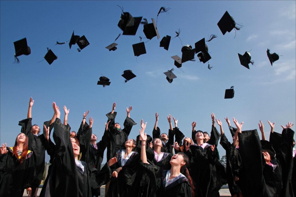 graduates throwing cap in the air social media accounts