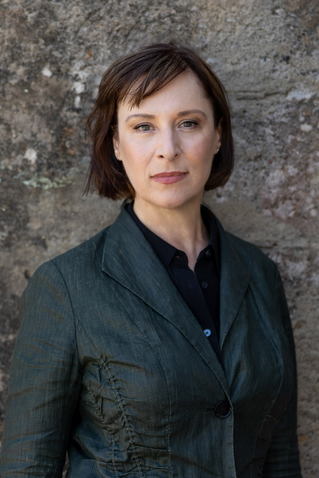 Female outdoor headshot on textured wall