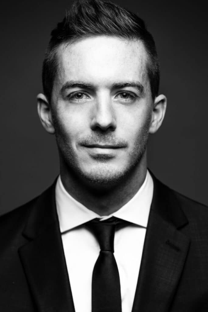 headshot portrait of smartly dressed man in black and white