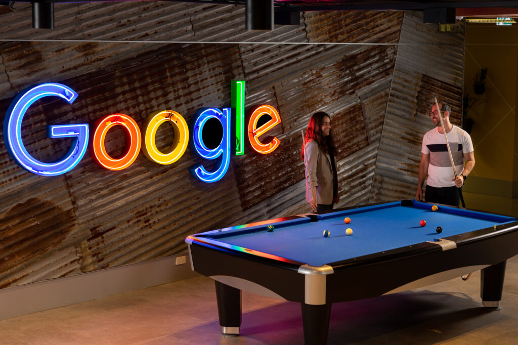 Workplace stock imagery of google team playing pool