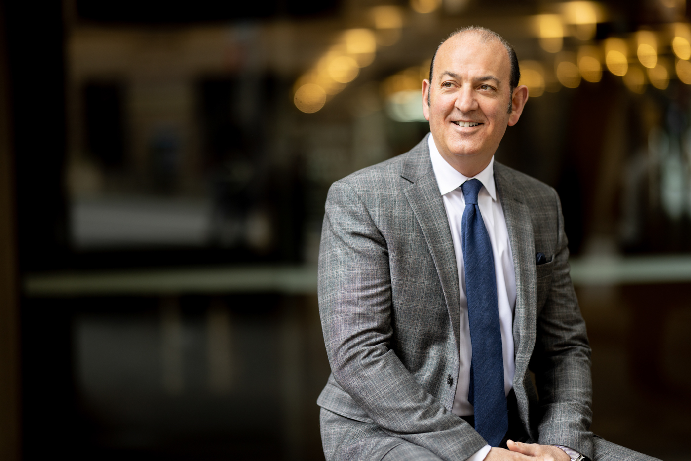 This is a photo of a man sitting down wearing a suit