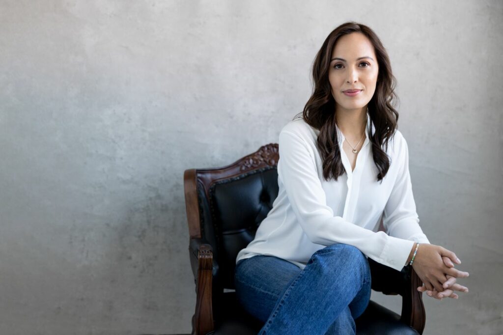 female seated in antique chair