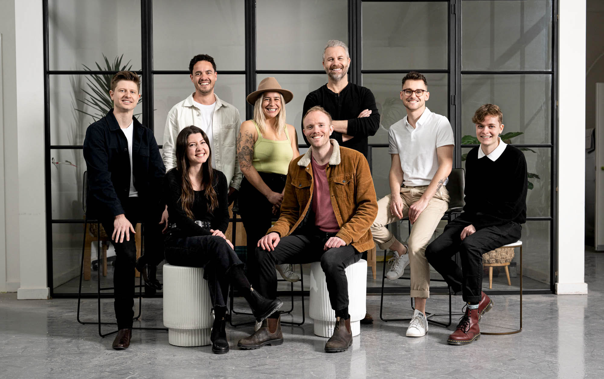 Relaxed team portrait of people sitting and smiling