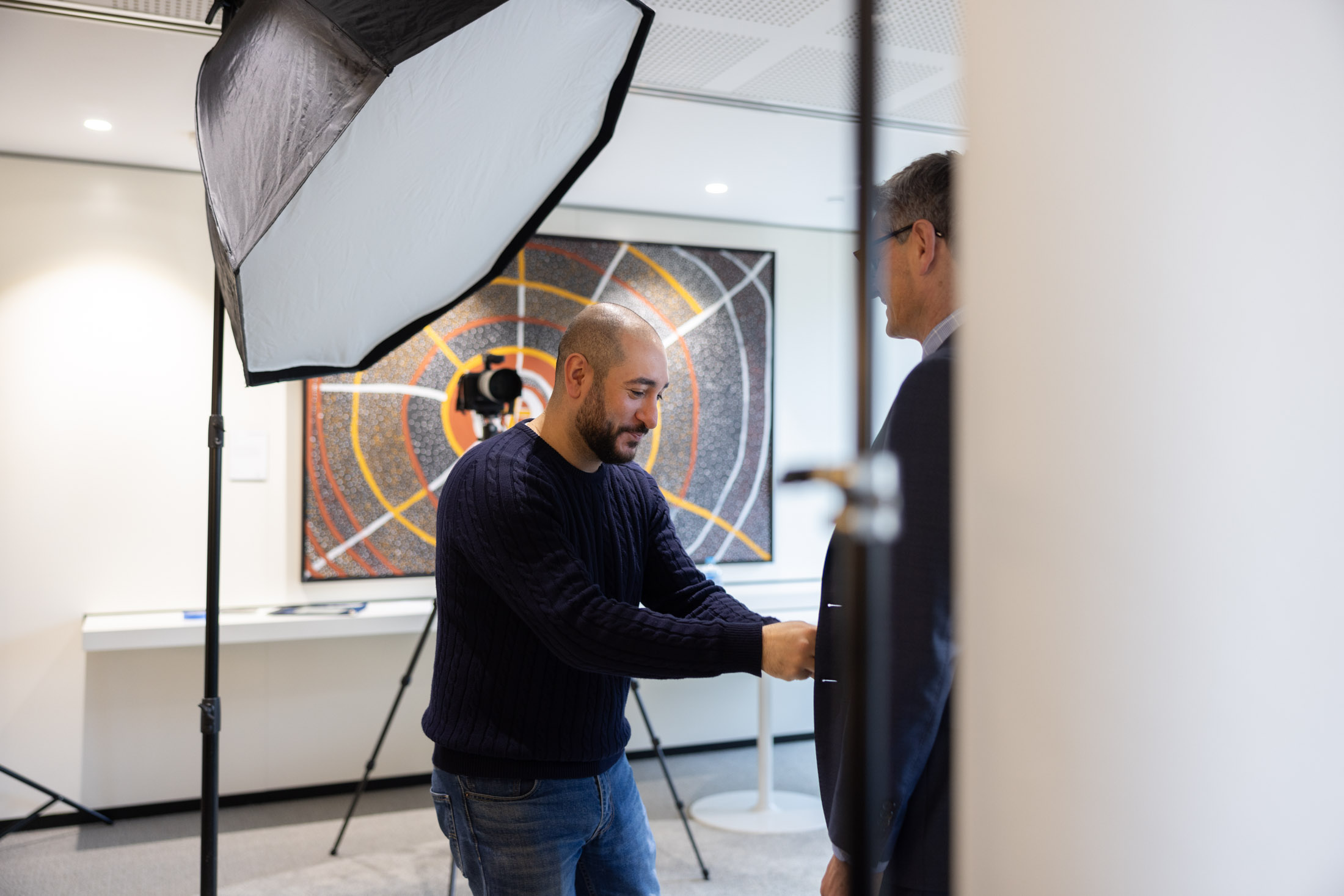 headshot photographer helping a customer clean his clothes