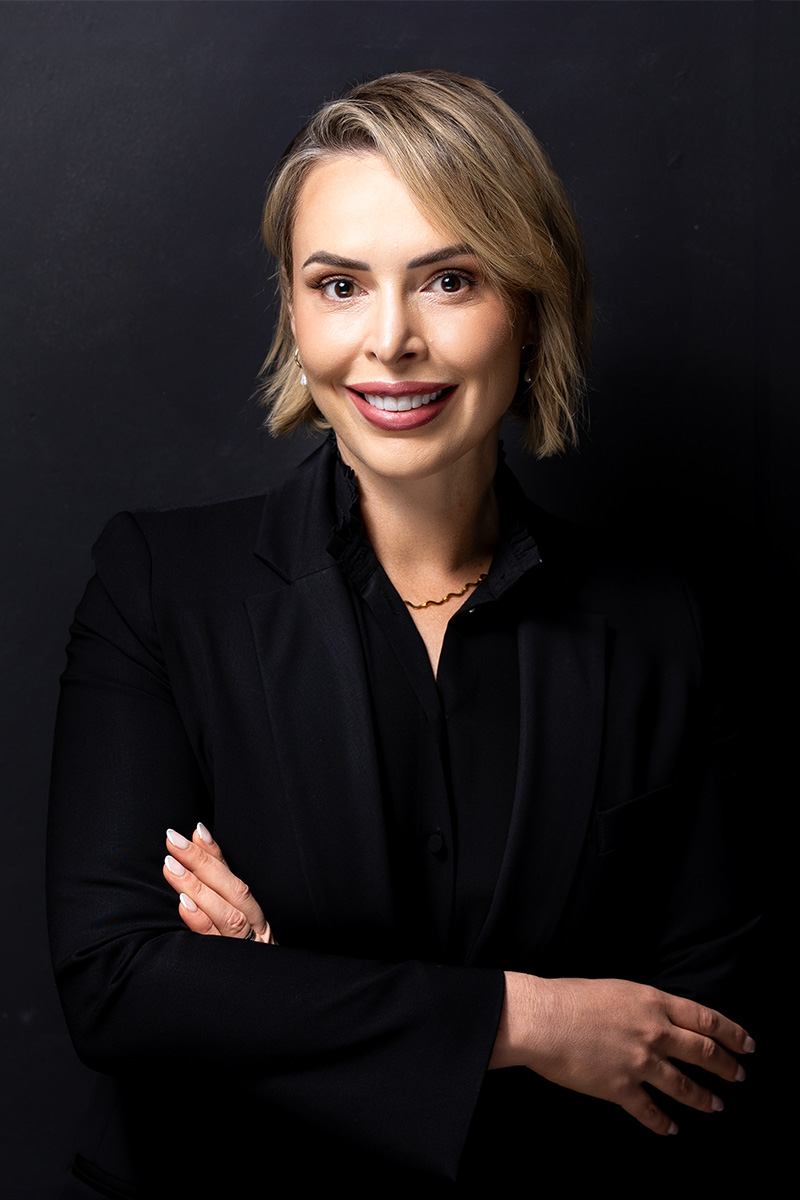 Business headshot of female on black wall